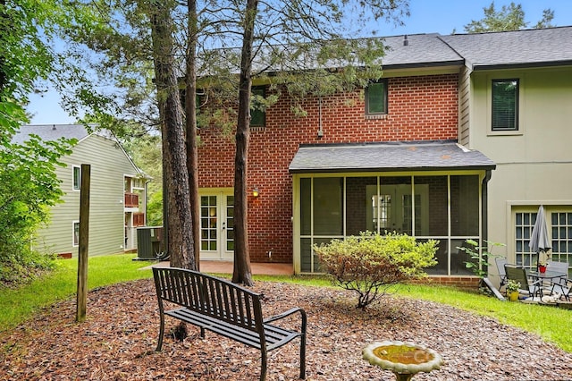 1035 Wexford Pl NW, Concord, NC 28027 - back of house featuring a sunroom, french doors, brick siding, and a shingled roof