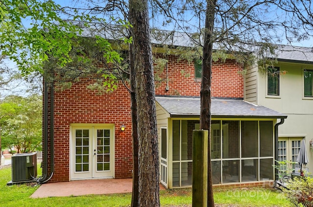 1035 Wexford Pl NW, Concord, NC 28027 - rear view of property with cooling unit, a sunroom, roof with shingles, and brick siding
