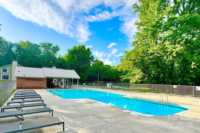 1035 Wexford Pl NW, Concord, NC 28027 - community pool with a patio area and view of scattered trees