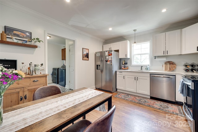 203 Lincoln St, Belmont, NC 28012 - kitchen featuring stainless steel appliances, crown molding, a sink, white cabinets, and separate washer and dryer