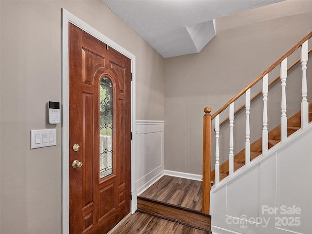181 Junaluska Oaks Dr, Waynesville, NC 28786 - entrance foyer with wood finished floors, wainscoting, and stairway