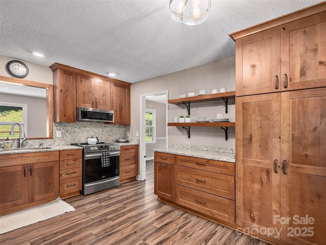 181 Junaluska Oaks Dr, Waynesville, NC 28786 - kitchen with appliances with stainless steel finishes, dark wood-style floors, brown cabinets, backsplash, and open shelves