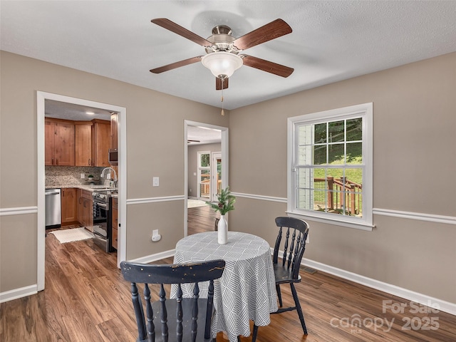 181 Junaluska Oaks Dr, Waynesville, NC 28786 - dining space featuring wood finished floors, healthy amount of natural light, and a ceiling fan