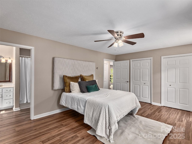 181 Junaluska Oaks Dr, Waynesville, NC 28786 - bedroom with wood finished floors, two closets, and a ceiling fan