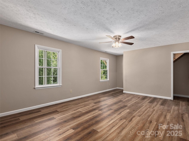 181 Junaluska Oaks Dr, Waynesville, NC 28786 - empty room with healthy amount of natural light, ceiling fan, a textured ceiling, and wood finished floors