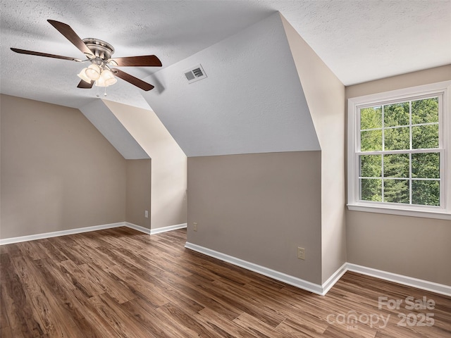 181 Junaluska Oaks Dr, Waynesville, NC 28786 - additional living space with a textured ceiling, wood finished floors, a ceiling fan, and lofted ceiling