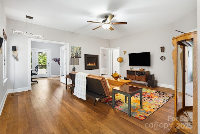 28 Richie St, Asheville, NC 28801 - living room featuring hardwood / wood-style floors, a ceiling fan, baseboards, and a glass covered fireplace