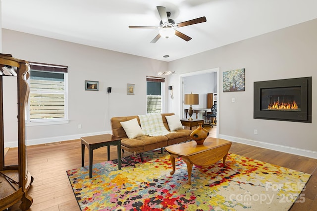 28 Richie St, Asheville, NC 28801 - living room with a glass covered fireplace, ceiling fan, light wood-style floors, and baseboards