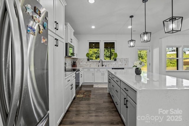 3127 Pinehills Way, Mount Holly, NC 28120 - kitchen featuring appliances with stainless steel finishes, decorative backsplash, a kitchen island, recessed lighting, and a sink
