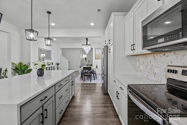 3127 Pinehills Way, Mount Holly, NC 28120 - kitchen with appliances with stainless steel finishes, dark wood-style flooring, white cabinets, decorative backsplash, and recessed lighting