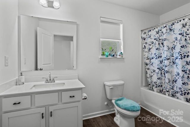 3127 Pinehills Way, Mount Holly, NC 28120 - full bathroom with vanity, wood finished floors, toilet, shower / bath combo with shower curtain, and baseboards