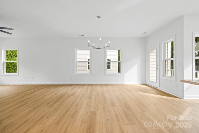 3924 Hager Dr, Charlotte, NC 28208 - unfurnished dining area with light wood-style flooring, a chandelier, plenty of natural light, and baseboards