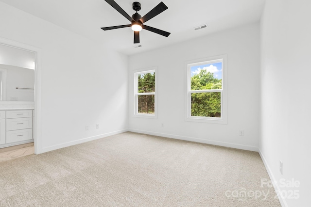 3924 Hager Dr, Charlotte, NC 28208 - unfurnished bedroom with light colored carpet, baseboards, connected bathroom, and ceiling fan