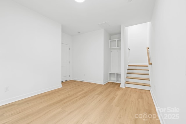 3924 Hager Dr, Charlotte, NC 28208 - empty room with light wood-type flooring, baseboards, and stairs