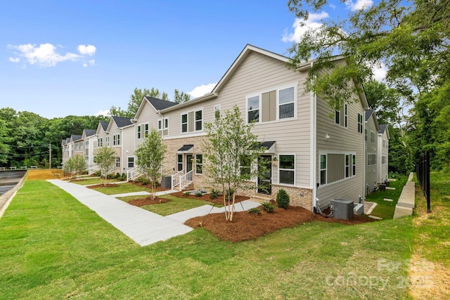 3924 Hager Dr, Charlotte, NC 28208 - view of front facade featuring central AC, brick siding, and a front lawn