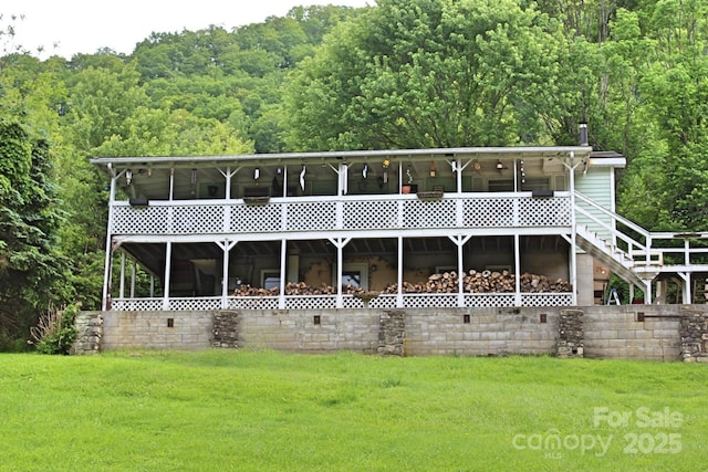 75 Unity Dr, Waynesville, NC 28786 - rear view of house with a yard and a view of trees