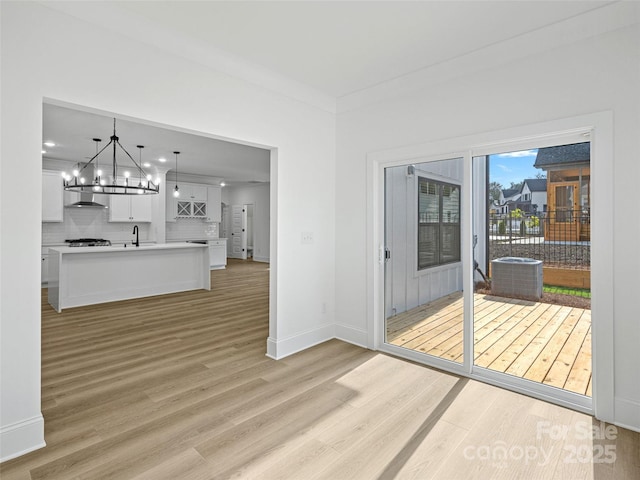 8315 Adrian Ct, Charlotte, NC 28270 - unfurnished living room featuring a chandelier and light wood finished floors