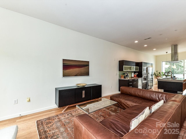 314 Viburnum Way Ct, Charlotte, NC 28208 - living room with light wood-style flooring, baseboards, and recessed lighting