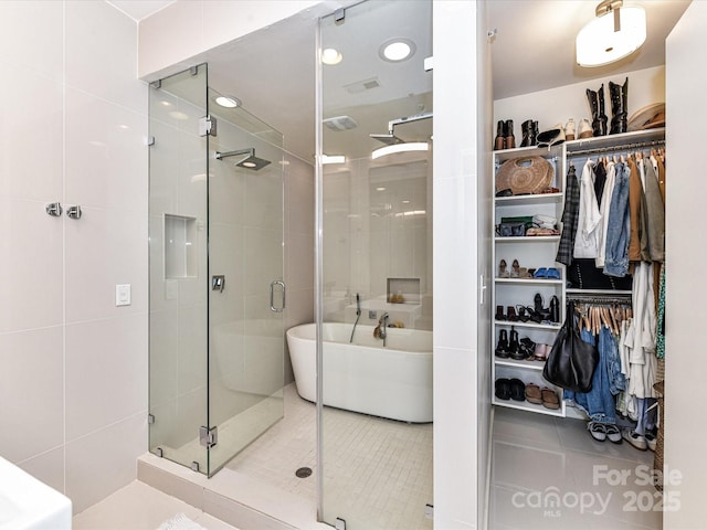 314 Viburnum Way Ct, Charlotte, NC 28208 - bathroom with a freestanding bath, a stall shower, a spacious closet, and tile patterned flooring