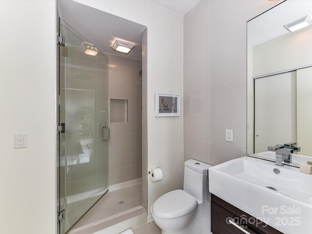 314 Viburnum Way Ct, Charlotte, NC 28208 - bathroom with tile walls, toilet, vanity, and a stall shower