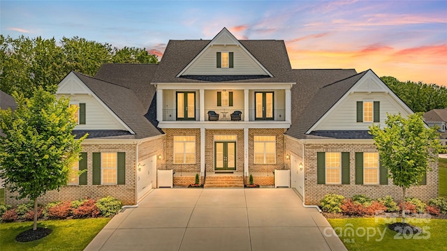 1702 Batson Creek Ln, Weddington, NC 28104 - view of front of house with concrete driveway, french doors, brick siding, and a shingled roof