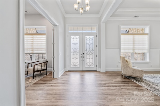 1702 Batson Creek Ln, Weddington, NC 28104 - entryway featuring a chandelier, wood finished floors, healthy amount of natural light, ornamental molding, and french doors