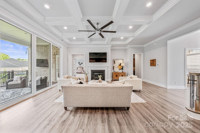1702 Batson Creek Ln, Weddington, NC 28104 - living room with a ceiling fan, light wood-type flooring, a glass covered fireplace, beamed ceiling, and coffered ceiling