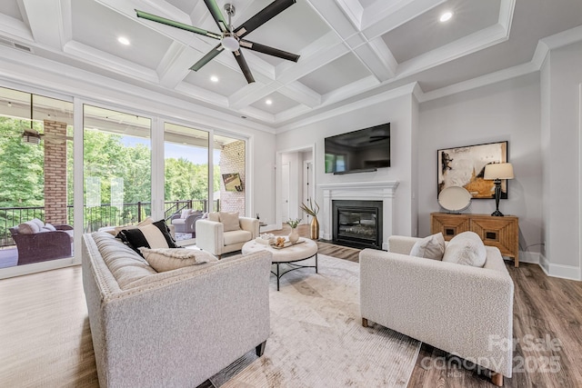 1702 Batson Creek Ln, Weddington, NC 28104 - living room with ceiling fan, a glass covered fireplace, coffered ceiling, beam ceiling, and wood finished floors
