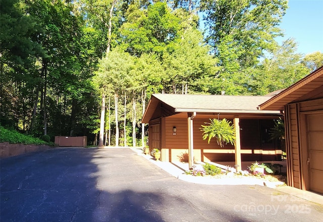 308 Woodfield Dr, Asheville, NC 28803 - view of side of property featuring a shingled roof and asphalt driveway