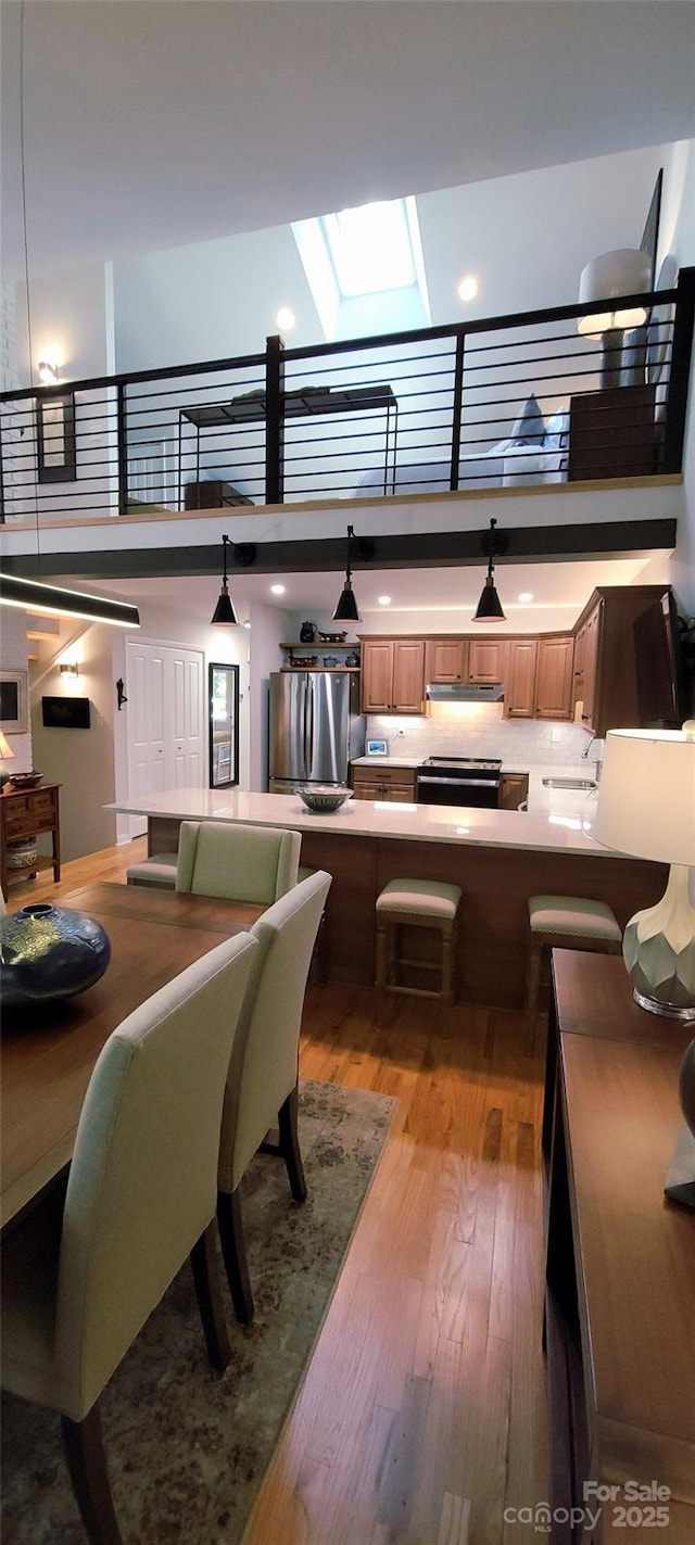 308 Woodfield Dr, Asheville, NC 28803 - dining area with a towering ceiling, wood finished floors, and a skylight