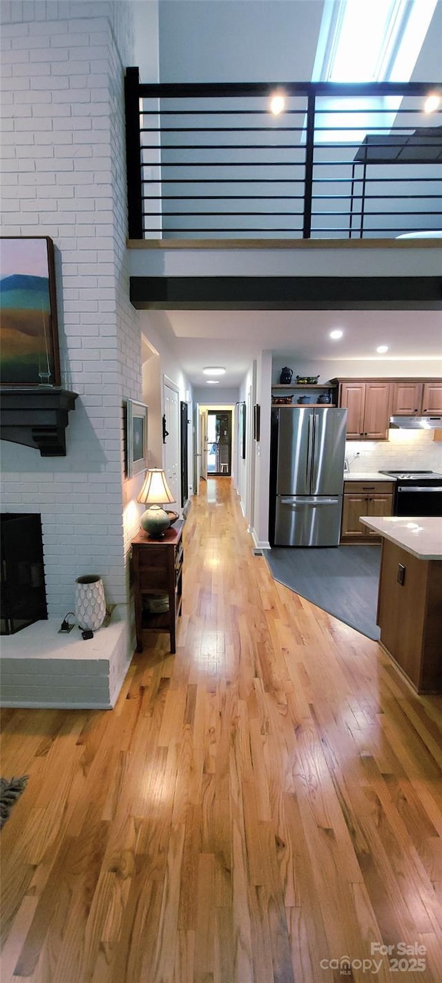 308 Woodfield Dr, Asheville, NC 28803 - living area with a high ceiling, light wood-type flooring, and a fireplace