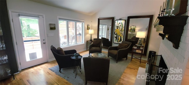 308 Woodfield Dr, Asheville, NC 28803 - living area featuring vaulted ceiling, light wood-style flooring, and baseboards