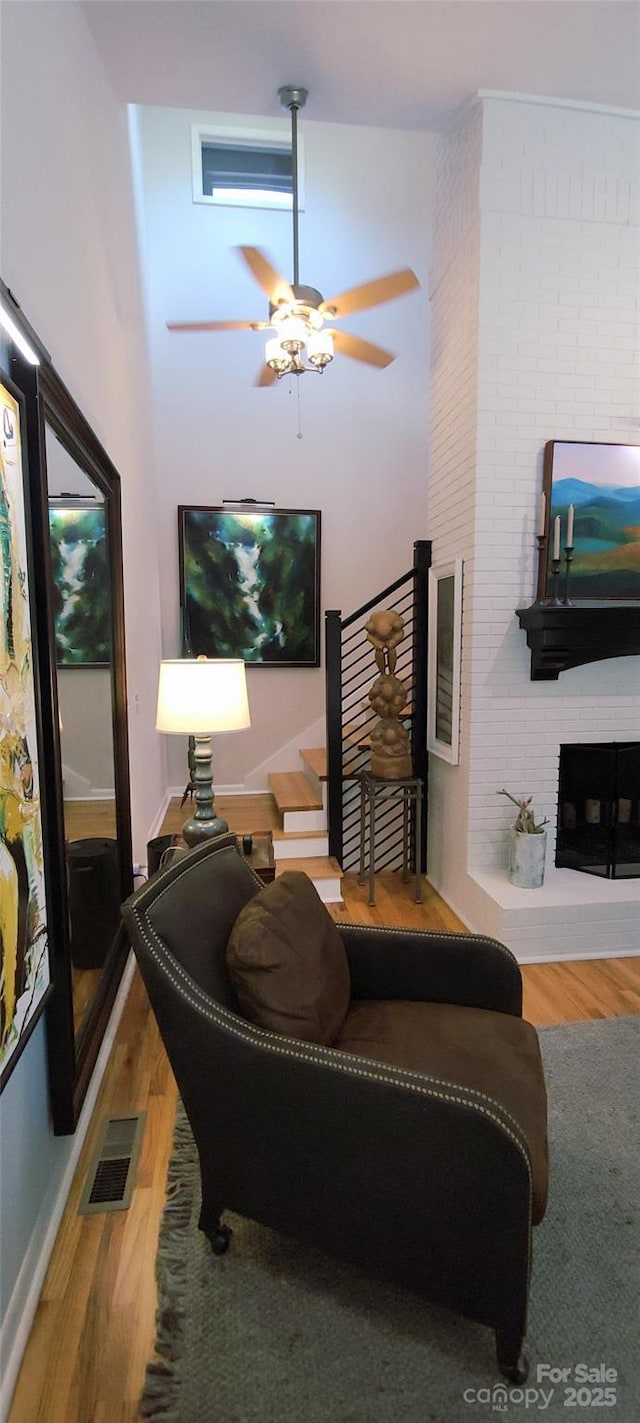308 Woodfield Dr, Asheville, NC 28803 - living area featuring wood finished floors, ceiling fan, and a fireplace