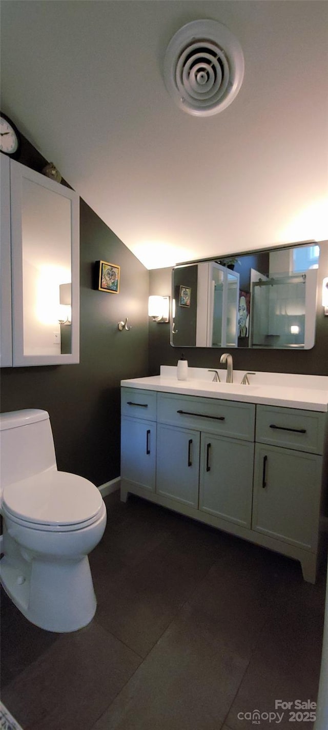 308 Woodfield Dr, Asheville, NC 28803 - full bathroom featuring tile patterned flooring, toilet, vanity, lofted ceiling, and baseboards
