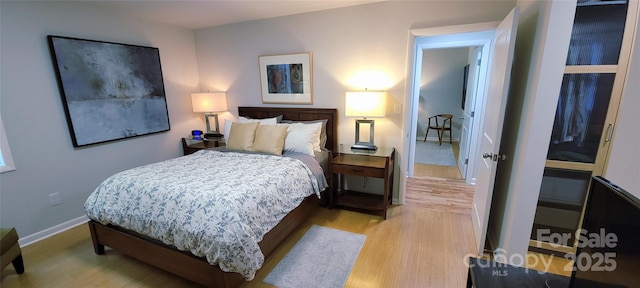 308 Woodfield Dr, Asheville, NC 28803 - bedroom featuring light wood-style floors and baseboards