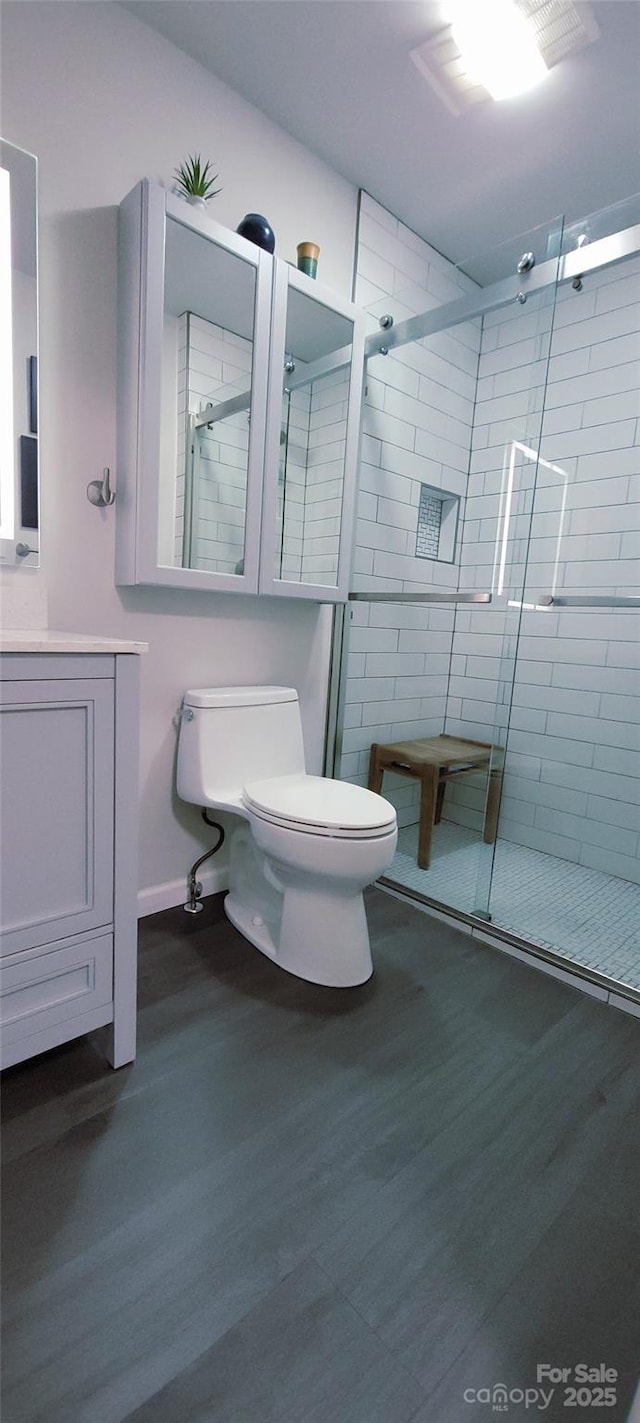 308 Woodfield Dr, Asheville, NC 28803 - full bathroom featuring toilet, a stall shower, wood finished floors, and vanity