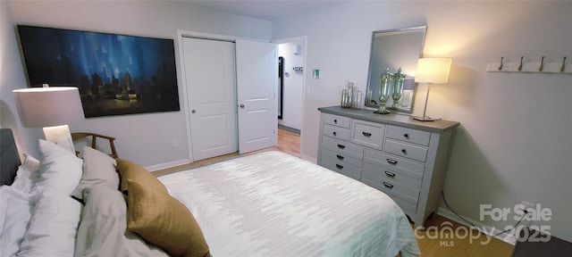 308 Woodfield Dr, Asheville, NC 28803 - bedroom with light wood-type flooring and a closet