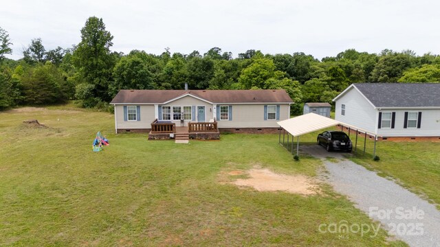 1007 W Cabaniss Rd, Shelby, NC 28150 - view of front of home with crawl space, a front lawn, gravel driveway, and a carport