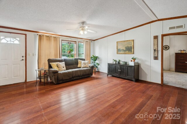 1007 W Cabaniss Rd, Shelby, NC 28150 - living area with crown molding, ceiling fan, wood finished floors, lofted ceiling, and a textured ceiling