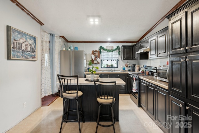 1007 W Cabaniss Rd, Shelby, NC 28150 - kitchen featuring stainless steel appliances, crown molding, light countertops, a kitchen island, and a kitchen breakfast bar