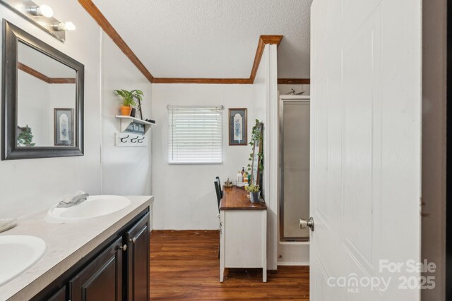 1007 W Cabaniss Rd, Shelby, NC 28150 - full bath with double vanity, a stall shower, crown molding, wood finished floors, and a textured ceiling