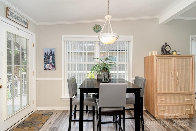 161 Badin Lake Cir, New London, NC 28127 - dining space featuring healthy amount of natural light, wood finished floors, baseboards, and ornamental molding