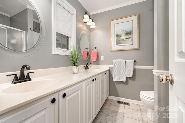 161 Badin Lake Cir, New London, NC 28127 - bathroom featuring toilet, double vanity, crown molding, tile patterned flooring, and baseboards