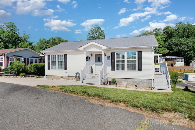 161 Badin Lake Cir, New London, NC 28127 - view of front of house featuring a front lawn and a shingled roof