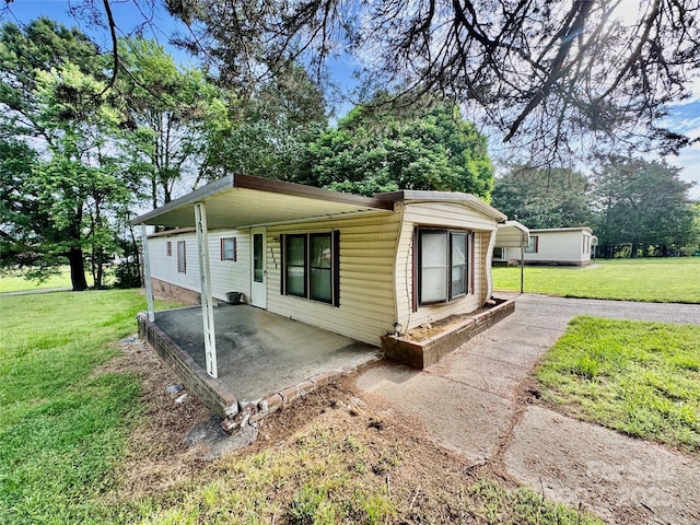 1733 S NC-16 Business Hwy, Stanley, NC 28164 - rear view of property with a yard, a patio area, and view of wooded area