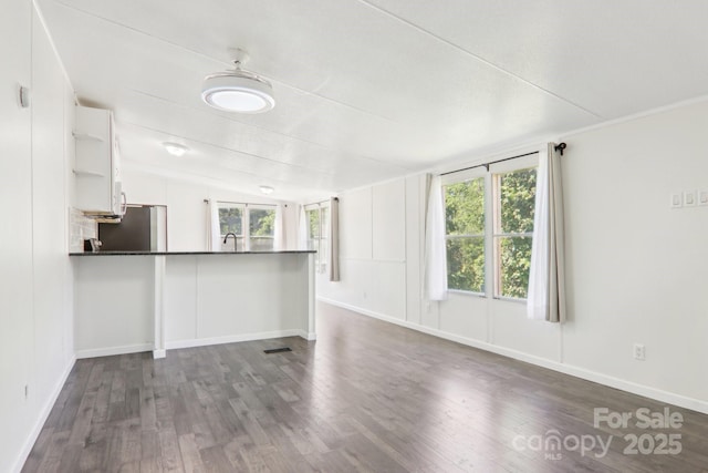 85 Star Flower Rd, Alexander, NC 28701 - unfurnished living room with dark wood finished floors, a sink, baseboards, and vaulted ceiling