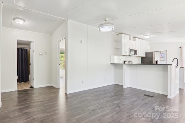 85 Star Flower Rd, Alexander, NC 28701 - kitchen featuring open shelves, white microwave, dark countertops, dark wood-style floors, and white cabinetry