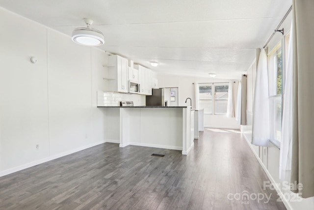 85 Star Flower Rd, Alexander, NC 28701 - kitchen featuring white microwave, stainless steel fridge with ice dispenser, open shelves, dark wood-type flooring, and a peninsula