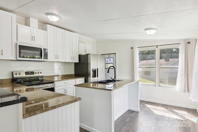 85 Star Flower Rd, Alexander, NC 28701 - kitchen with stainless steel appliances, a sink, dark wood finished floors, an island with sink, and decorative backsplash