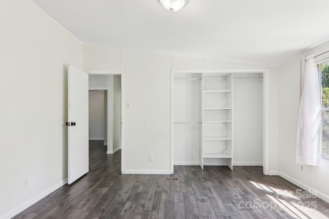 85 Star Flower Rd, Alexander, NC 28701 - unfurnished bedroom with dark wood-type flooring, a closet, baseboards, and vaulted ceiling